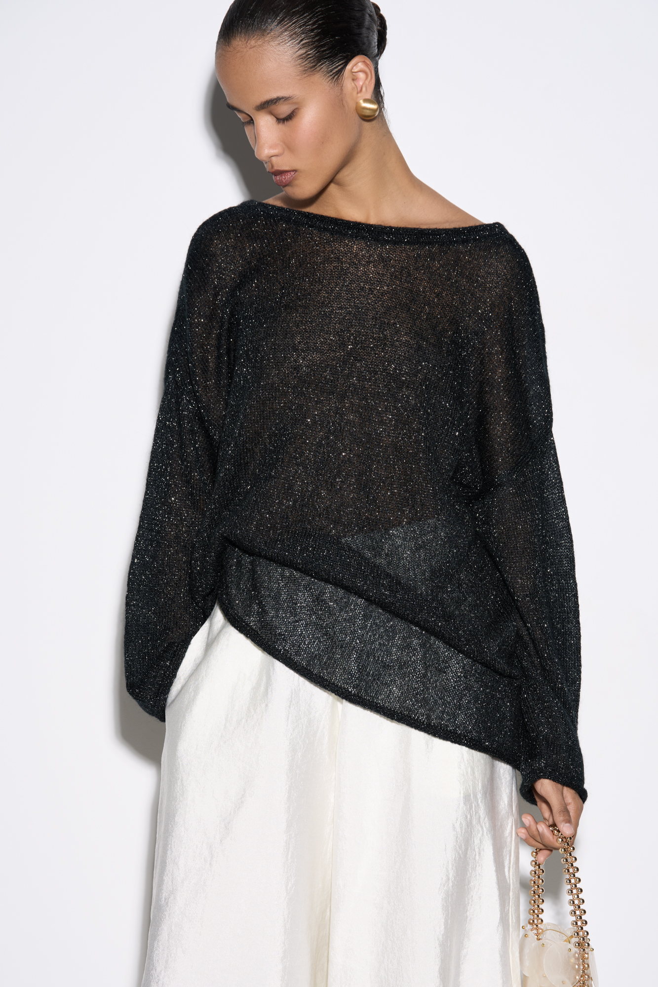 Полупрозрачный трикотажный джемпер с люрексом. Модель свободного силуэта с длинным рукавом и глубоким вырезом на спине.