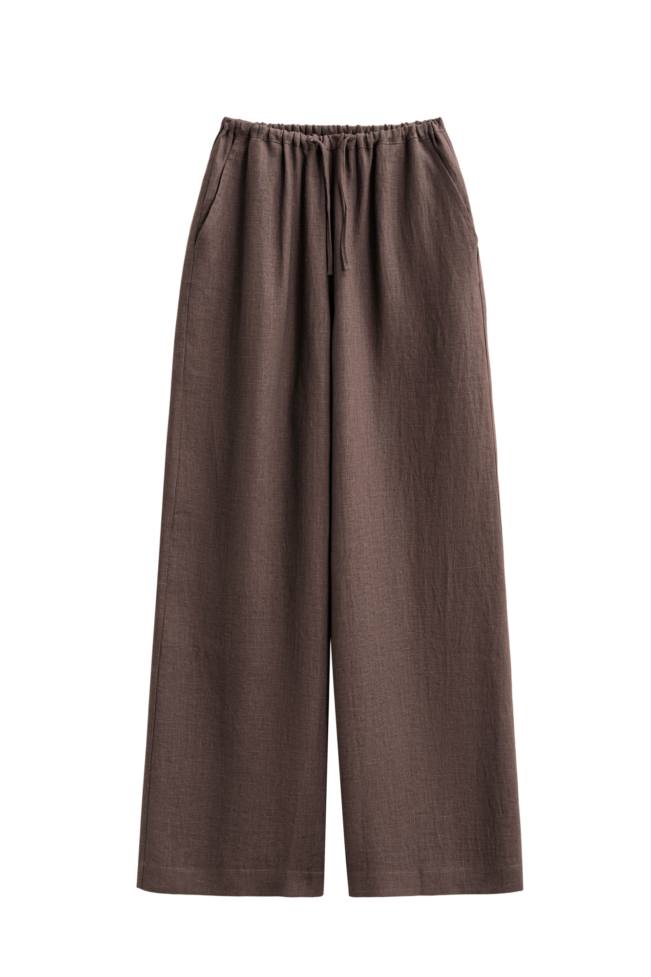 Широкие брюки из 100% льна. Модель свободного прямого кроя с врезными карманами по бокам. Изделие выполнено с поясом на узкой резинке, дополненным кулиской.