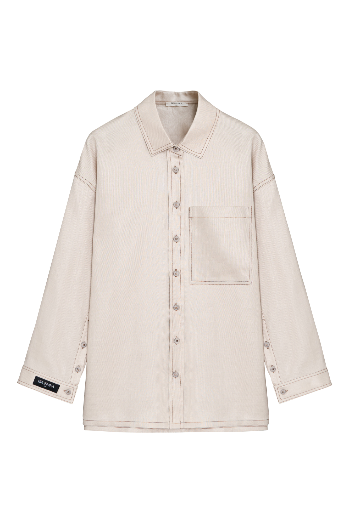 Льняная рубашка с накладным карманом на груди и брендированным ярлыком. Модель свободного силуэта со спущенной линией плеча. Манжеты на пуговицах.