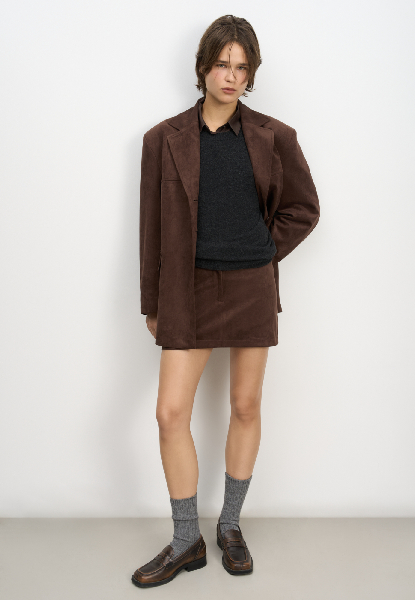 Юбка длины мини из ткани с имитацией внешнего вида и свойств натуральной замши. Застежка на скрытую пуговицу и молнию спереди.