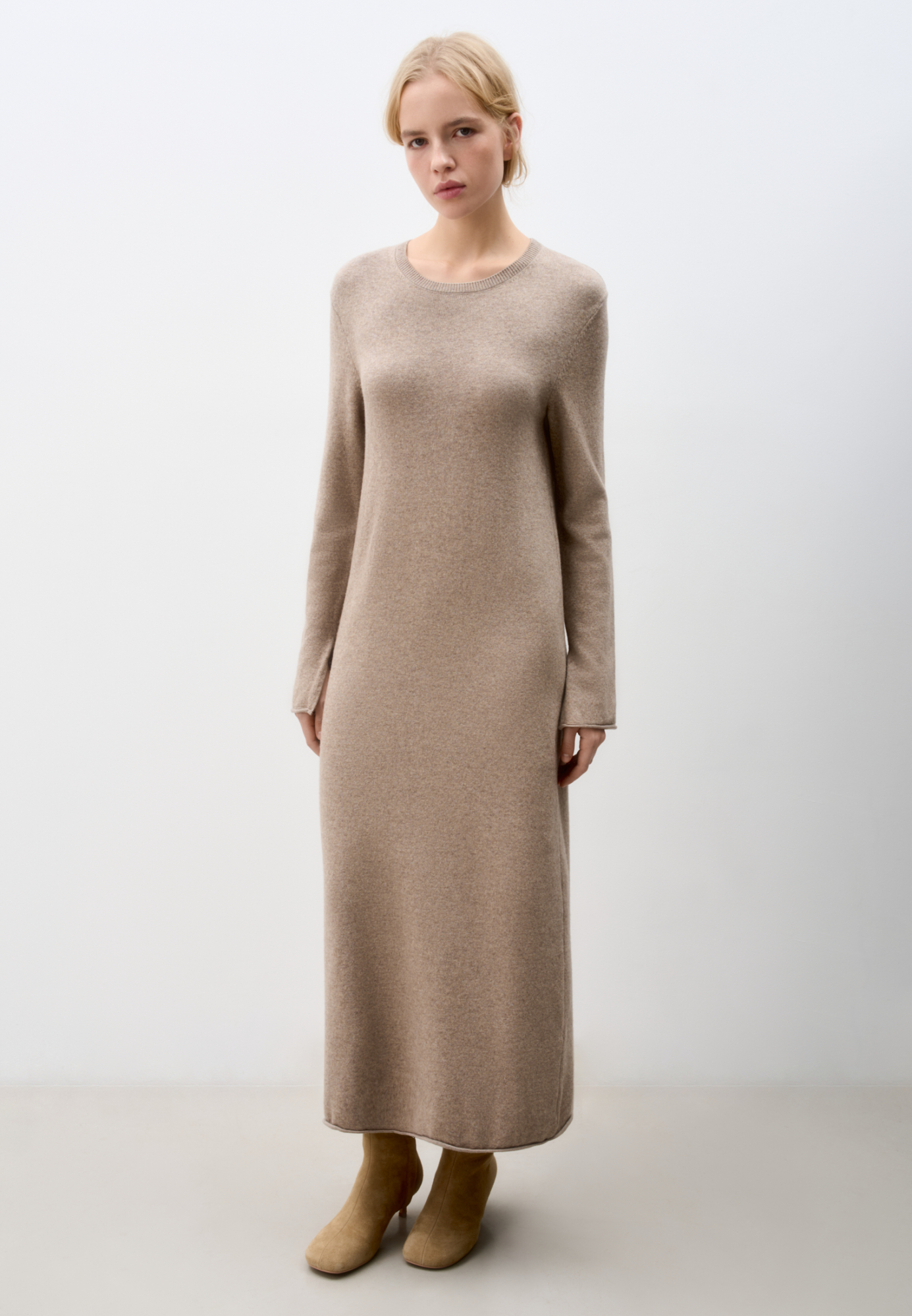 Трикотажное платье длины макси из шерсти с добавлением кашемира. Модель свободного силуэта с длинными рукавами, круглым вырезом горловины и валиком по низу изделия.