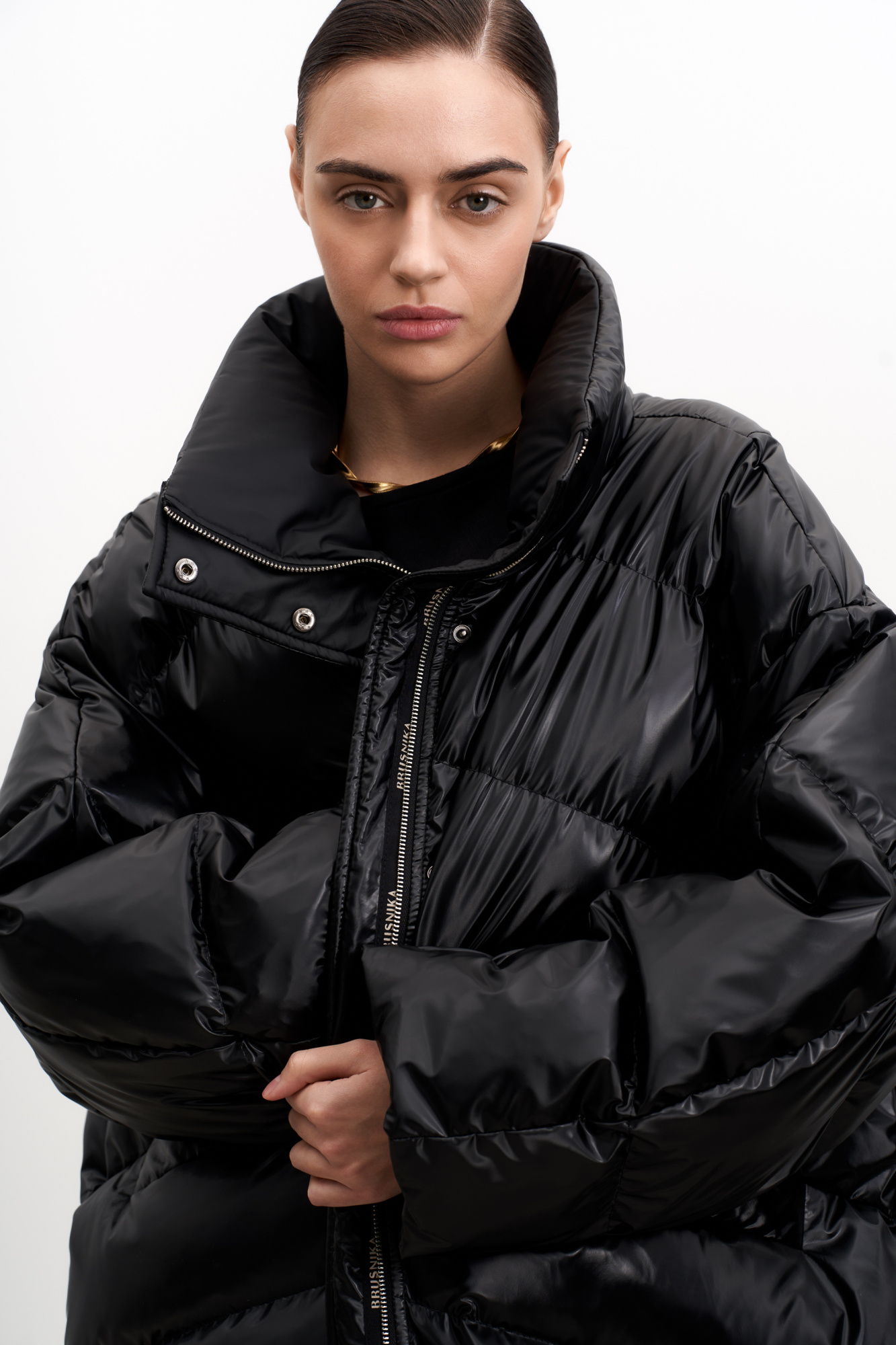 Объемный стеганый пуховик с воротником-стойкой. Модель с боковыми карманами и застежкой на молнию и кнопки.