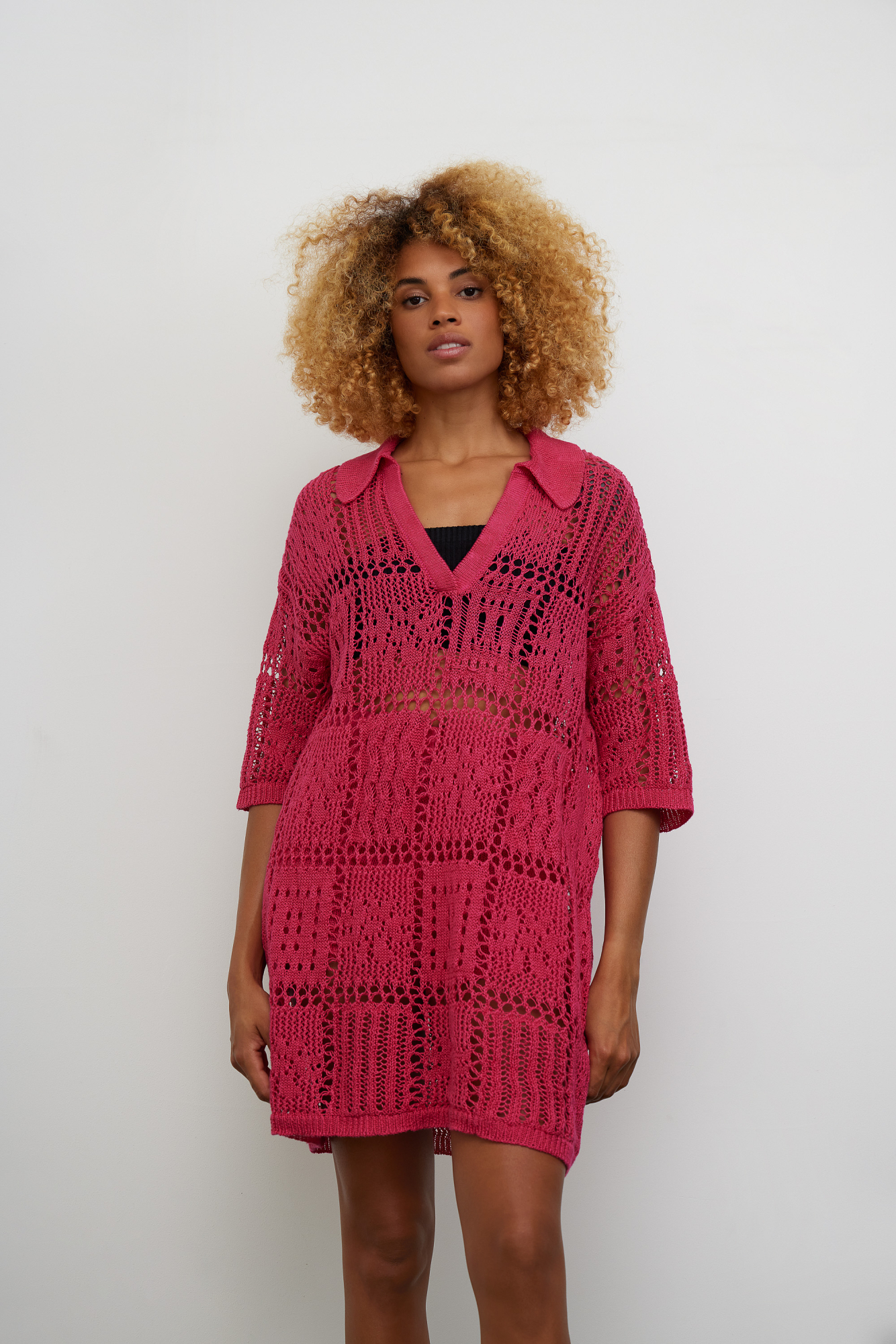 Трикотажный комплект из 100% льна, состоящий из платья длины мини и шорт. Ажурное платье со спущенной линией плеч, рукавом 3/4, V-образным вырезом и отложным воротником. Шорты прямого кроя с эластичным поясом. Края изделия выполнены в рубчик. 