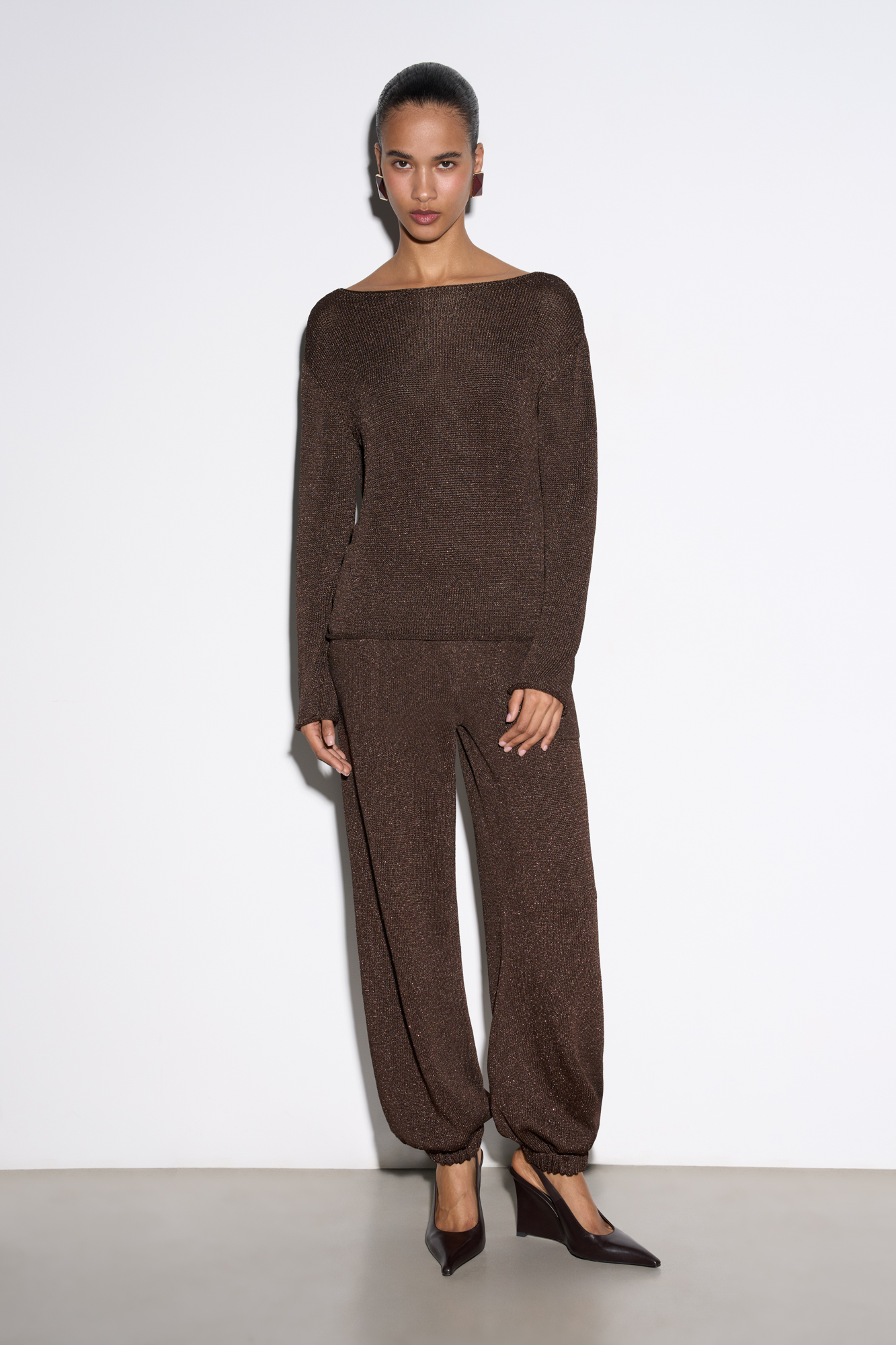 Лонгслив из вискозы с люрексом. Модель с вырезом-лодочкой и длинными рукавами. Манжеты рукавов и низ изделия декорированы валиками.&nbsp;&nbsp;