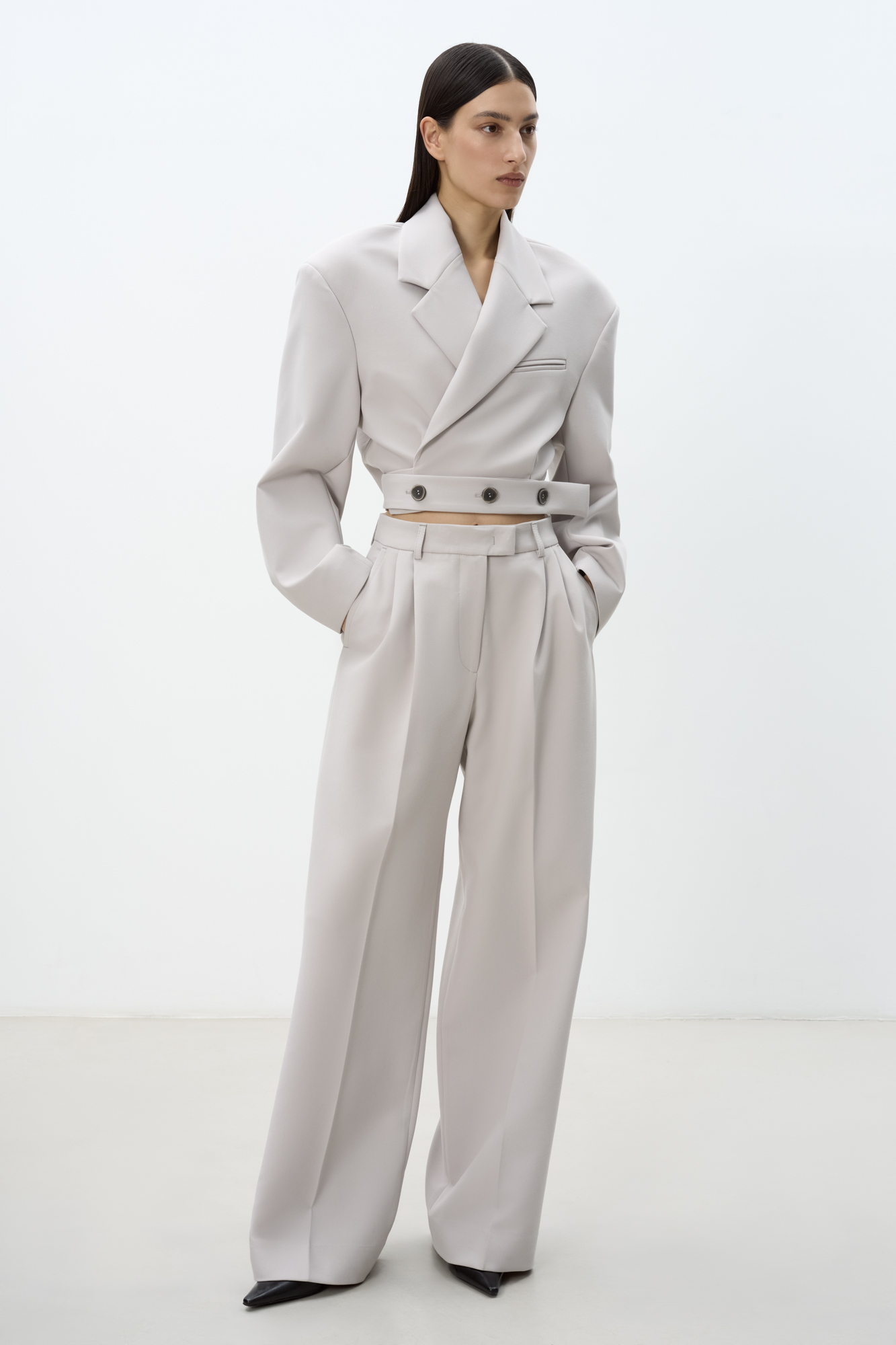 Укороченный жакет на запах с поясом. Отложной воротник с прямоугольными лацканами и декоративный нагрудный карман с кантом. Модель приталенного силуэта с подкладкой, манжеты на пуговицах.