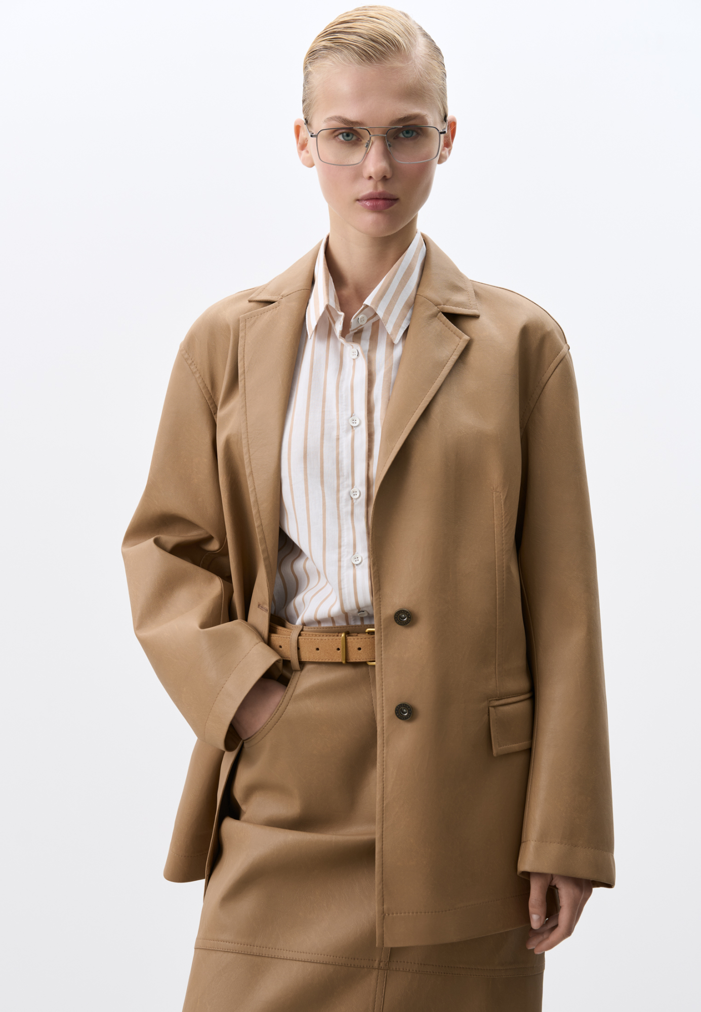 Однобортный жакет прямого кроя из пластичной двусторонней экокожи. Передние карманы с клапанами. Застежка на пуговицы.