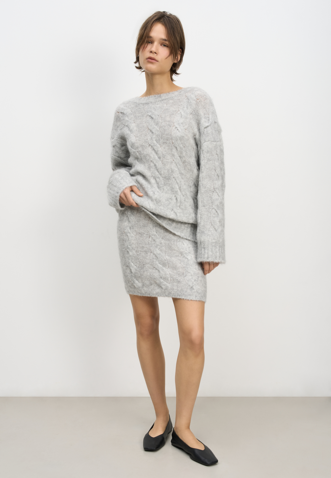 Трикотажная юбка длины мини с косами из шерсти и мохера. Модель приталенного силуэта с эластичным поясом в рубчик.