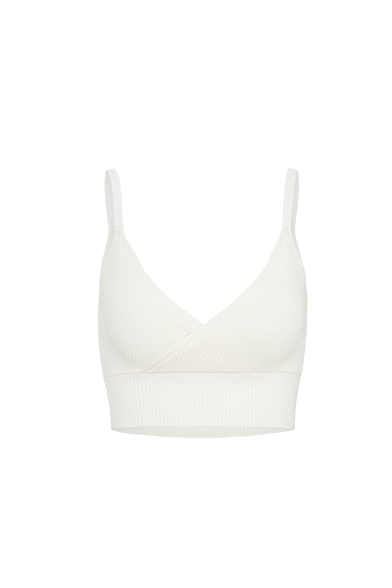 Фактурный кроп-топ из вискозы на тонких бретелях. Модель с имитацией запаха на лифе и широкой эластичной резинкой.