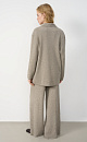 Трикотажный двубортный жакет из шерсти с добавлением вискозы и шелка. Модель прямого кроя, с лацканами, двумя накладными карманами и валиками на манжетах. Застежка на пуговицы. Без подкладки. 