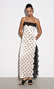 Атласное платье-комбинация длины макси в горох. Модель приталенного силуэта на тонких бретельках и высоким разрезом сбоку. Изделие декорировано кружевом.