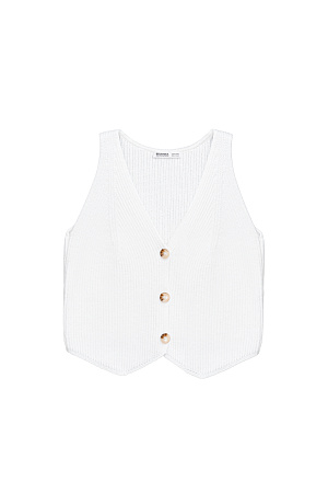 белый Трикотажный жилет из хлопка. Модель прямого кроя с V-образным вырезом и застежкой на пуговицы. Дополнить образ можно юбкой в таком же стиле.
