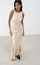 Атласное платье длины макси. Модель приталенного силуэта, с круглым вырезом горловины, без рукавов. Модель декорирована асимметричной юбкой и драпировкой на талии.
