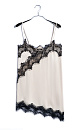 Платье-комбинация длины мини из 100% вискозы. Модель на тонких бретельках. Подол и лиф изделия декорированы тонким кружевом контрастного цвета.