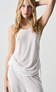 Трикотажная майка из вискозы. Модель свободного силуэта, без рукавов, на широких бретельках, с U-вырезом горловины и глубокой проймой. Кулиски по бокам изделия позволяют регулировать длину и создавать драпировку.