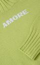 Трикотажный джемпер из 100% хлопка. Модель свободного силуэта со спущенной линией плеч, высоким воротом и вывязанной надписью "Amore" на груди.