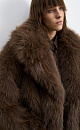 Шуба из экомеха на запах. Модель с широким отложным воротником, шлевками для пояса из экокожи и врезными карманами. Изделие выполнено на подкладке.