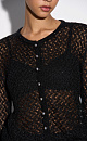 Трикотажный ажурный кардиган из кидмохера, декорированный мелкими пайетками. Модель свободного силуэта с длинными рукавами, круглым вырезом горловины и застежкой на жемчужные пуговицы. 