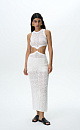 Трикотажный ажурный сарафан из хлопка с добавлением эластана. Модель без рукавов, с круглым вырезом горловины. Сарафан декорирован кольцом, соединящим верх и юбку изделия. Края выполнены в рубчик.