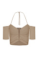 Трикотажный укороченный топ, декорированный металлической перемычкой на груди. Модель с открытыми плечами, короткими рукавами и тонкими бретелями, завязывающимися на шее.