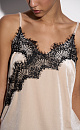 Топ из бархатной вискозы, декорированный тонким кружевом. Модель асимметричного кроя, с глубоким вырезом декольте на тонких бретельках.