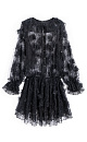Платье длины мини из тонкого кружева с объемным декором в виде цветов. Модель свободного кроя с длинными рукавами, манжетами, и круглым вырезом горловины с жабо. Застежка на пуговицы. Горловина фиксируется на шее тонким шнурком. Изделие выполнено без подкладки.