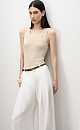 Трикотажный ажурный топ из вискозы с вывязанным орнаментом сердечками. Модель приталенного силуэта, с круглым вырезом горловины, без рукавов, на широких лямках. Края изделия выполнены в рубчик.