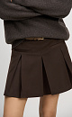 Юбка длины мини из шерсти. Модель прямого кроя, с крупными складками, поясом со шлевками для ремня, врезными карманами спереди и застежкой на молнию. Изделие без подкладки.