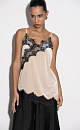 Топ из бархатной вискозы, декорированный тонким кружевом. Модель асимметричного кроя, с глубоким вырезом декольте на тонких бретельках.