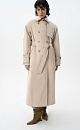 Двубортный длинный тренч прямого кроя. Модель с отложным воротником, декорированным металлической перемычкой, отлетной кокеткой, патами с пуговицами на манжетах, карманами и шлевками на талии для пояса. 